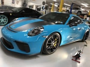 Custom blue GT3 Porsche during auto detail service